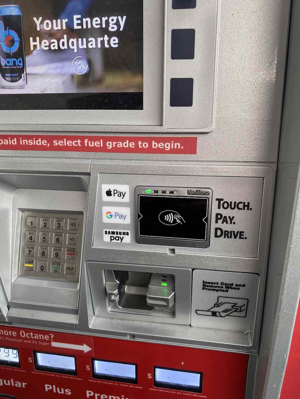 A photo of gas station pump with Apple Pay logo